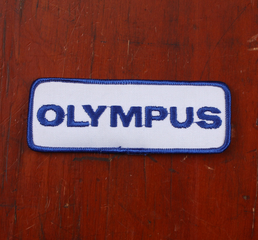 OLYMPUS DEALER PROMO ITEM: BLUE AND WHITE PATCH, 4.75 INCHES LONG/65925 - Picture 1 of 1